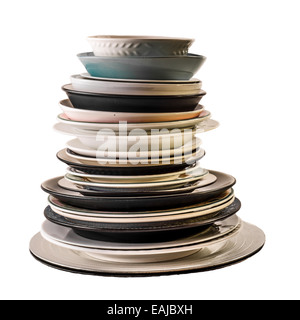 Assorted plates of different shapes, sizes and colours, all stacked one on top of the other, and photographed on a white backgro Stock Photo