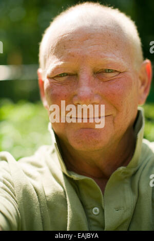 headshot portrait happy smiling middle age senior handsome man in casual polo shirt shallow depth of field Stock Photo