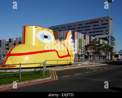 Yellow Submarine sculpture and the Hampton by Hilton hotel & car park, Liverpool John Lennon Airport, Liverpool, England, UK Stock Photo