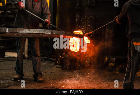 Hot steel ingot in the workspace Stock Photo