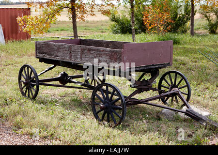 old wooden and metal farm wagon made from vehicle wheels and axle in depression era leader Saskatchewan Canada Stock Photo