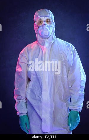 Scientist in Hazmat suit and protective gear over blue background Stock Photo