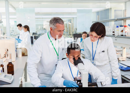 Scientists using microscope in laboratory Stock Photo