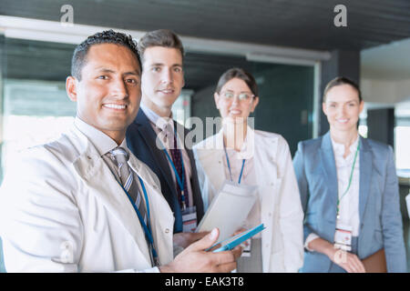 Scientists and business people smiling in laboratory Stock Photo