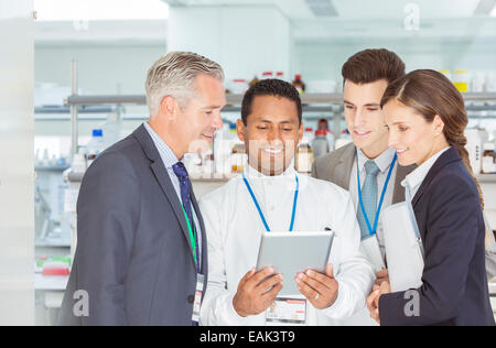 Scientist and business people using digital tablet in laboratory Stock Photo