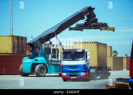 Crane near cargo container on truck Stock Photo