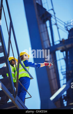 Low angle view of workers on cargo crane Stock Photo