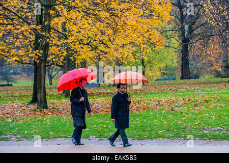 London, UK. 17th November, 2014. UK weather. Commuters walk through the autumn colours of Green Park with their umbrellas raised. A good way to start the week. Green Park, London, UK 17 Nov 2014 Credit:  Guy Bell/Alamy Live News Stock Photo