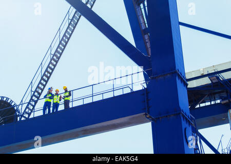 Low angle view of workers on cargo crane Stock Photo
