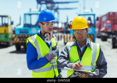Workers talking near trucks Stock Photo