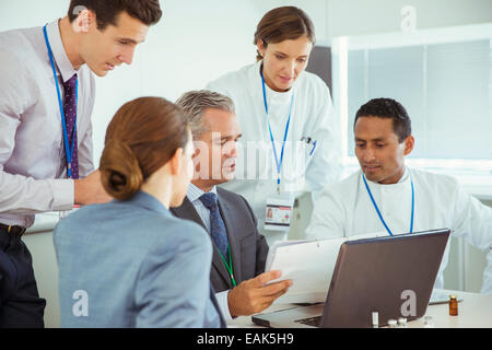 Scientists and business people talking in conference room Stock Photo