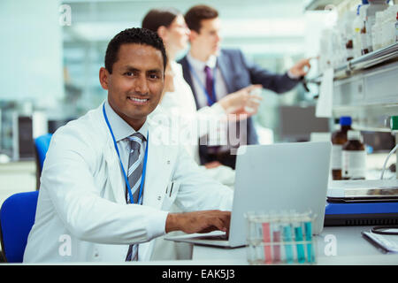 Scientist working on laptop in laboratory Stock Photo