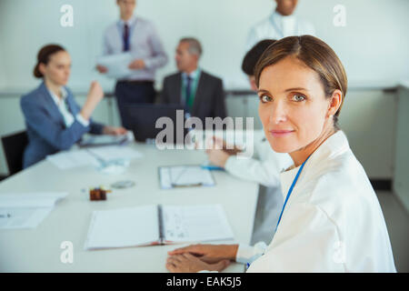 Scientist sitting in meeting Stock Photo