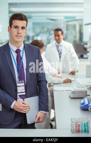 Businessman holding laptop in laboratory Stock Photo