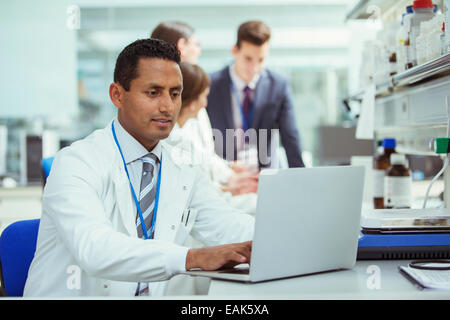 Scientist using laptop in laboratory Stock Photo