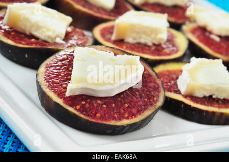 closeup of a plate with sliced figs with cheese, served as appetizer Stock Photo