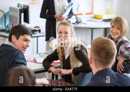 High School students sitting and smiling in classroom Stock Photo