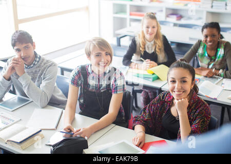 Teenage students learning in classroom Stock Photo