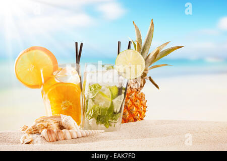 Exotic summer drinks in sand. Blur beach as background Stock Photo