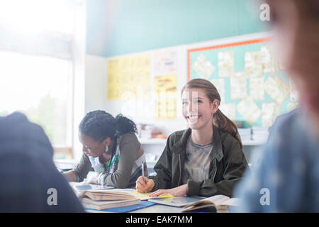 Teenage students learning in classroom Stock Photo