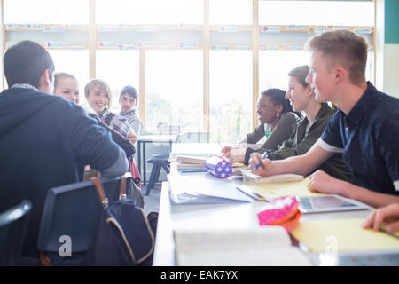 Students talking in classroom during lesson Stock Photo