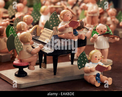 Handmade wooden angels playing musical instruments as a table decoration from the Erzgebirge or Ore Mountains, Germany Stock Photo