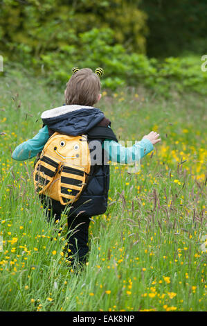 School boy exploring on a nature trail to find bees Stock Photo