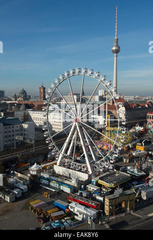 A giant wheel is seen at the Christmas market in front of the Alexa shopping center on Alexander Platz square in Berlin, Germany, 17 November 2014. The Berlin Cathedral, the Red City Hall and the television tower are seen in the background. The Alexa Christmas market runs from 24 November until 28 December 2014. Photo: Matthias Balk/dpa Stock Photo