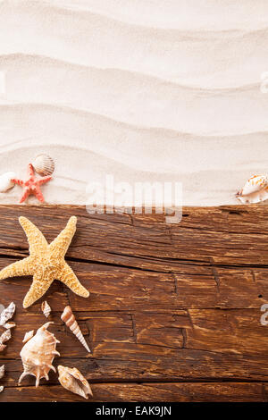 Concept of summer beach with starfish, shells and empty paper on wood Stock Photo