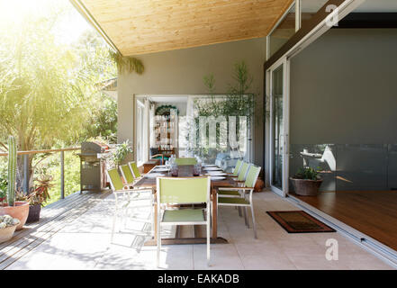 Dinning table and chairs in sunny patio Stock Photo