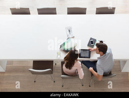Elevated view of couple using tablet pc in dining room Stock Photo