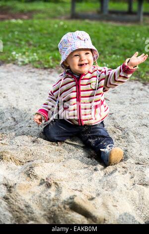 Baby, 12-14 Months, playing in the sand Stock Photo
