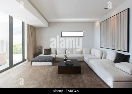 View of modern living room with sofas, coffee table and abstract painting Stock Photo
