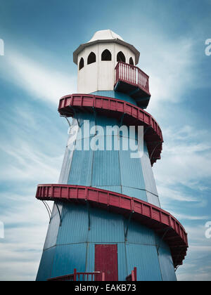 Vintage Helter skelter blue and red with white top against blue sky. Stock Photo