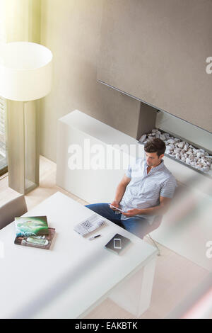 Man using tablet pc in modern dining room Stock Photo