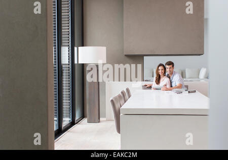 Portrait of couple with tablet pc in dining room Stock Photo