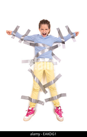 Young girl tied to the wall with duct tape Stock Photo
