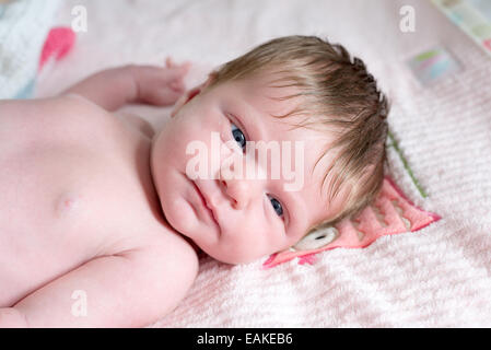 One week old newborn baby girl with lots of hair Stock Photo