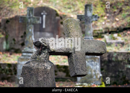 Ruined tombstone in old weathered cemetery Stock Photo