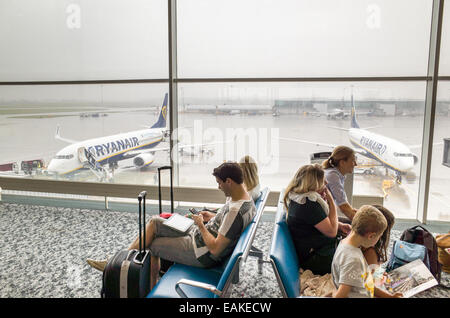 Passengers waiting to board Ryanair plane at Stansted Airport departure gate, England, UK Stock Photo