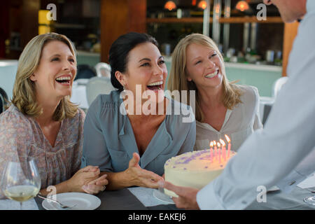 Man handing birthday cake to women Stock Photo