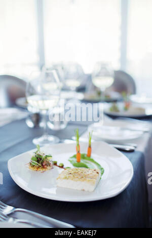 Fancy fish meal on plate in restaurant Stock Photo