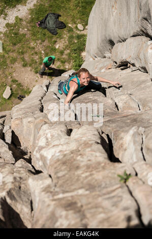 Italian girl climbs a 6b crack route in Balmanolesca, the most historical granite crag in Ossola. Varzo, Italy. Stock Photo