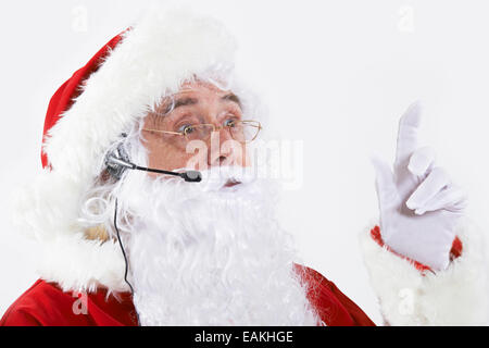 Studio Shot Of Santa Claus Wearing Headset Stock Photo