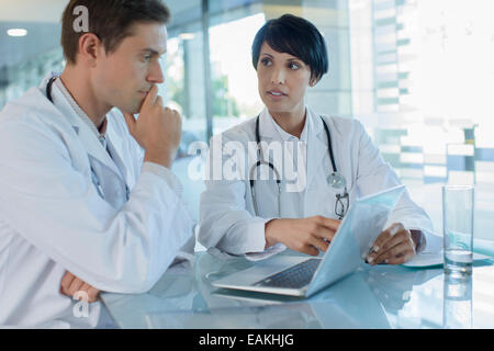 Female and male doctor using laptop in hospital office Stock Photo