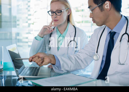 Doctors using laptop and discuss patient's treatment Stock Photo