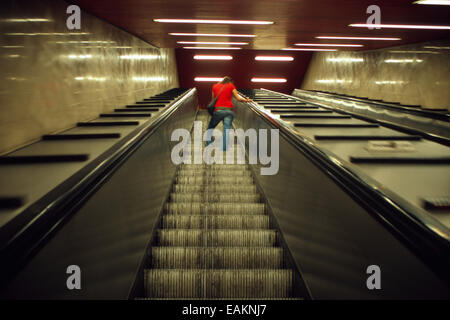 Italy, Lombardy, Milan, Metro, Subway Station, Young Woman on an Escalator Stock Photo