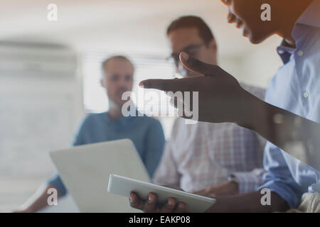 Businessmen using digital tablet and laptop in office Stock Photo