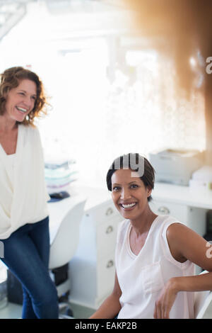 Portrait of two smiling women in office Stock Photo