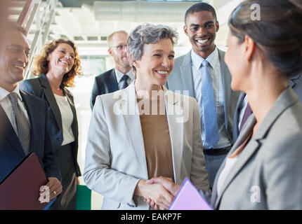 Office team congratulating businesswoman Stock Photo